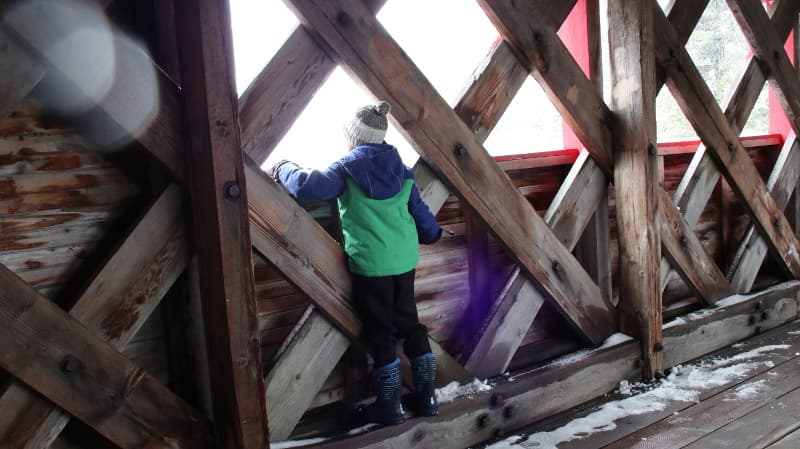 kid inside covered bridge